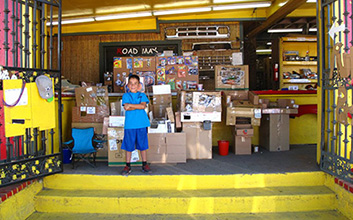 Caine in front of his store