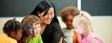 caregiver showing a group of children something amazing