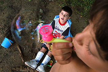 Samuel watching his brother blow bubbles