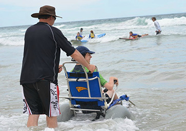 Enjoying the water while sitting in a beach wheelchair