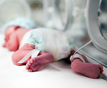 newborn boy sleeping in NICU