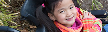 Girl in wheelchair smiling