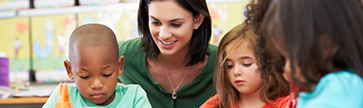 teacher with group of students doing homework