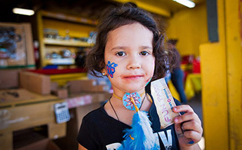 a girl holds up a fun pass