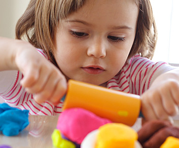 Girl rolling clay